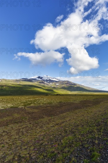 Barren volcanic landscape with a view of the snow-covered Snæfellsjökull volcano, Snäfellsjökull, Snaefellsjökull glacier, spring clouds, Snæfellsnes peninsula, Iceland