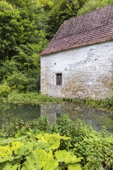 Old barn. The building is located near the source of the Zwiefalter Ach river at the Wimsen Cave excursion destination in the Swabian Alb. Hayingen, Baden-Württemberg, Germany