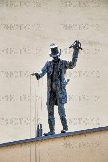 Bronze figure of puppeteer on the roof by artist Roland Lindner, Zeitz, Saxony-Anhalt, Germany