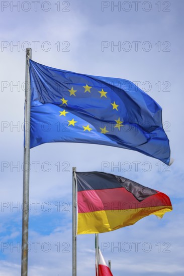Düsseldorf, North Rhine-Westphalia, Germany - European flag, German flag and North Rhine-Westphalia flag fluttering in the wind on flagpoles, symbolic image of EUROPA