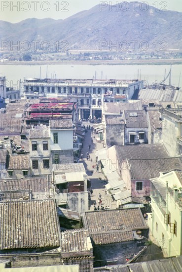 View over rooftops of traditional buildings in city centre from hilltop of Monte Fort, Macau, Asia 1964