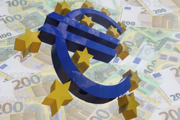 (Photomontage) euro sculpture cropped in front of euro banknotes