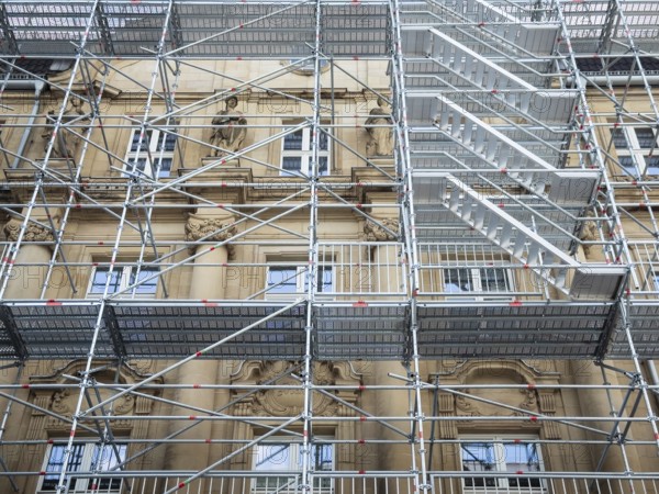 Scaffolded façade of the district court with metal platforms and stairs in Wuppertal, Germany