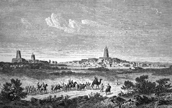 African oasis city Tombouctou or Timbuktu, clay towers of the mosques are UNESCO World Heritage Site, southern Sahara, desert, desertification, camel caravan, horses, transport of goods, traditional clay architecture, Islamic culture, Mali, historical illustration 1896