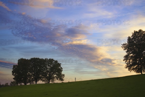 An impressive sky with colourful clouds at dusk over a green landscape, Siegen