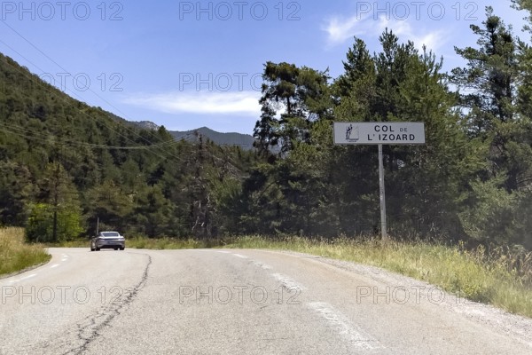 On the right tourist sign at the beginning of the mountain pass road to the Alpine pass with the inscription Col de l'Izoard, Col d'Izoard, Cottian Alps, Route des Grandes Alpes, Département Hautes-Alpes, France