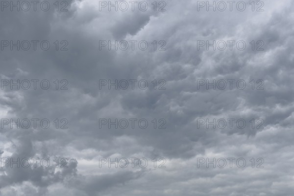 A gathering rain front of grey clouds forms a closed cloud cover, international