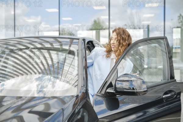 The woman opened the car door to sit inside and inspect the interior from the inside, AI generated