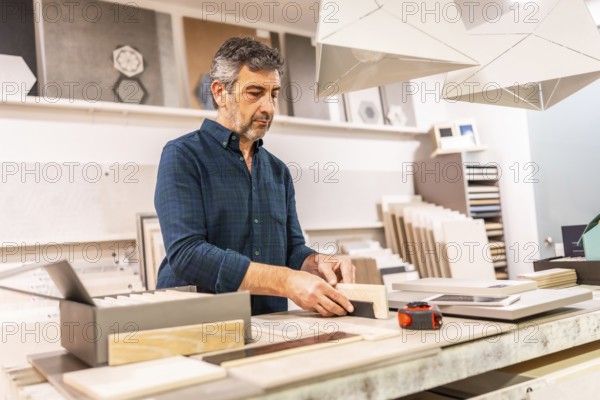 Architect choosing material samples in a home improvement store for an interior design project