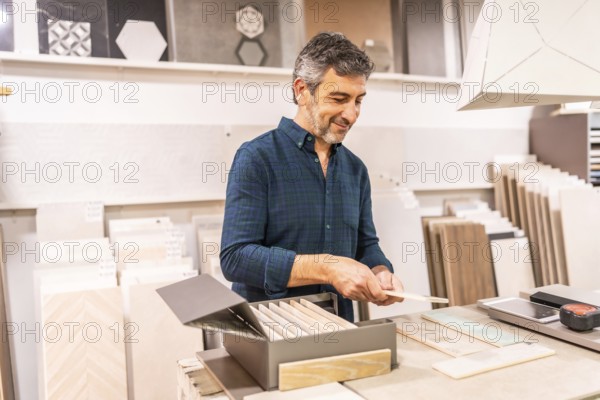Architect selecting ceramic tile samples in a home improvement store for a new bathroom or kitchen renovation project