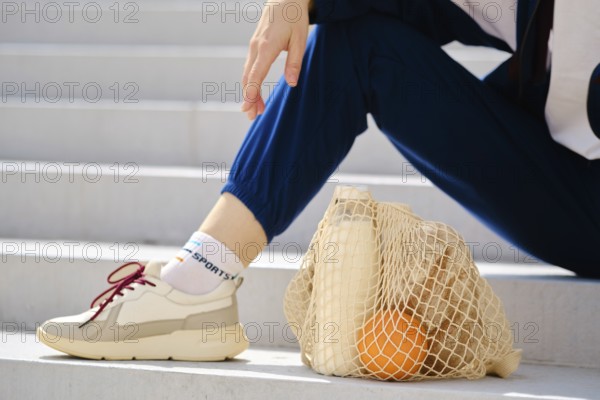 Essential food in reusable string bag on a stairs. Healthy living concept