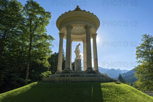 Statue of Venus with Cupid in the Temple of Venus above the terraced gardens, backlight, long shadows, blue sky, park of Linderhof Castle, UNESCO World Heritage Site, Ettal, Unterammergau, Garmisch-Partenkirchen, Upper Bavaria, Bavaria, Germany