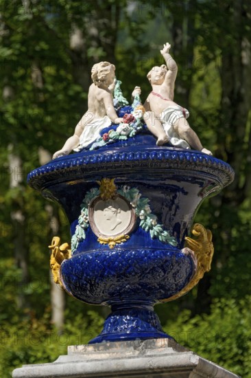 Vase with putti, ornamental vessel made of glazed ceramic in the Rococo style, west parterre, palace park of Linderhof Palace, UNESCO World Heritage Site, Ettal, Unterammergau, Garmisch-Partenkirchen, Upper Bavaria, Bavaria, Germany