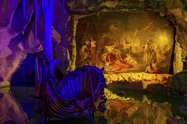 Colourful illumination of King Ludwig II's Venus Grotto, artificial stalactite cave, lake with boat, painting Tannhäuser bei Frau Venus by August von Heckel, park of Linderhof Castle, UNESCO World Heritage Site, Ettal, Unterammergau, Garmisch-Partenkirchen, Upper Bavaria, Bavaria, Germany