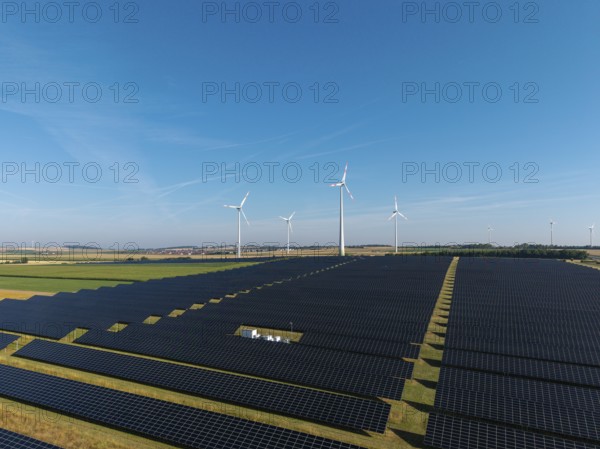 Extensive solar panels with wind turbines in sunny surroundings, near Kitzingen, Lower Franconia, Bavaria, Germany
