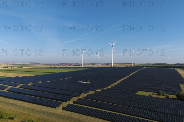 Extensive field with solar cells and wind turbines in rural area, near Kitzingen, Lower Franconia, Bavaria, Germany