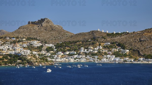 Coastal town on a blue sea with hill and castle in the background, lined with sailing boats, Pandeli Castle, Castle, Leros Fortress, St John's Fortress, Apitiki Hill, Pandeli Bay, Agia Marina, Leros, Dodecanese, Greek Islands, Greece