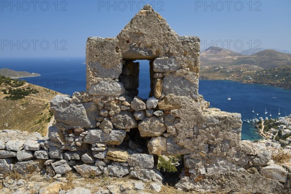 Stone ruin with window, sea and mountain landscape in the background under blue sky, Pandeli Castle, Castle, Leros Fortress, St John's Fortress, Apitiki Hill, Pandeli Bay, Agia Marina, Leros, Dodecanese, Greek Islands, Greece