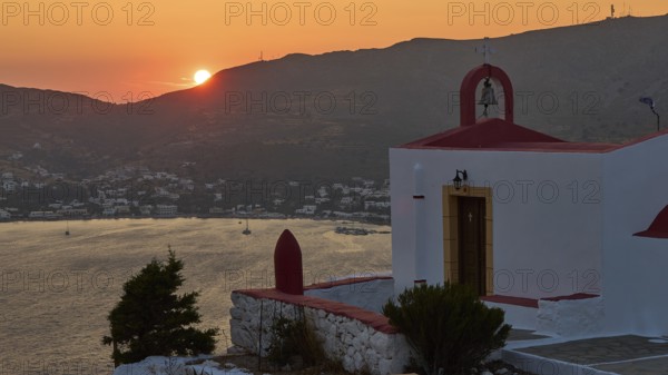 Silhouette of a chapel at sunset with sea and mountains in the background, Profitis Ilias Church, Prophet Elias Church, evening light, sunset, Ormos Alintas, Agia Marina, Leros, Dodecanese, Greek Islands, Greece