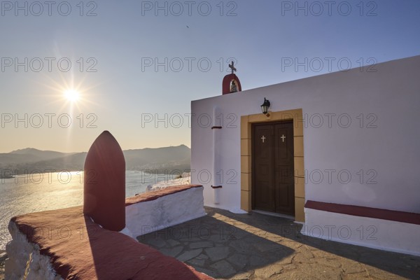 Chapel with a view of the sea at sunset, classic Mediterranean architecture, red-painted world war bomb, Profitis Ilias Church, Prophet Elias Church, evening light, sunset, Ormos Alintas, Agia Marina, Leros, Dodecanese, Greek Islands, Greece