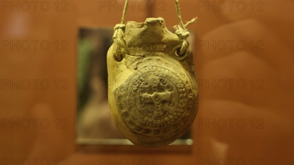 Ancient clay seal in a museum, hung with rope and detailed engravings, Archaeological Museum, Agia Marina, Leros, Dodecanese, Greek Islands, Greece