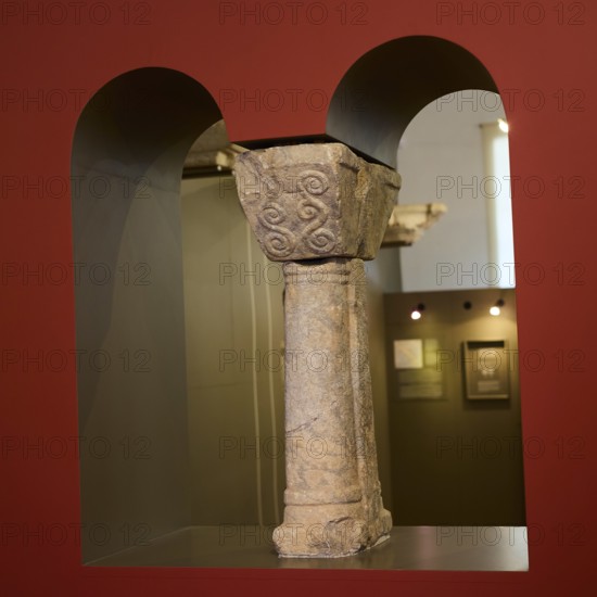 Part of an ancient stone column with relief-like decorations in a museum room, Archaeological Museum, Agia Marina, Leros, Dodecanese, Greek Islands, Greece