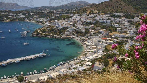 View of a Greek coastal town with flowers and yachts surrounded by blue sea, Pandeli Castle, Castle, Leros Fortress, St John's Fortress, Apitiki Hill, Pandeli Bay, Windmills, Leros, Dodecanese, Greek Islands, Greece