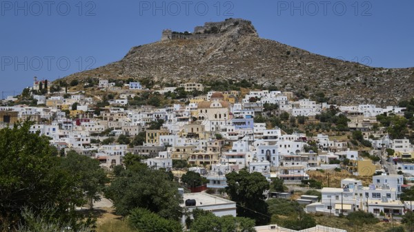 White village on the slope of a rocky mountain under a blue sky, Pandeli Castle, castle, Leros Fortress, St John's Fortress, Apitiki Hill, Pandeli Bay, windmills, Leros, Dodecanese, Greek Islands, Greece