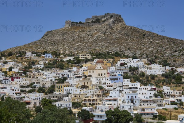 White village below a rocky castle on a hill, Pandeli Castle, castle, Leros Fortress, St John's Fortress, Apitiki Hill, Pandeli Bay, windmills, Leros, Dodecanese, Greek Islands, Greece