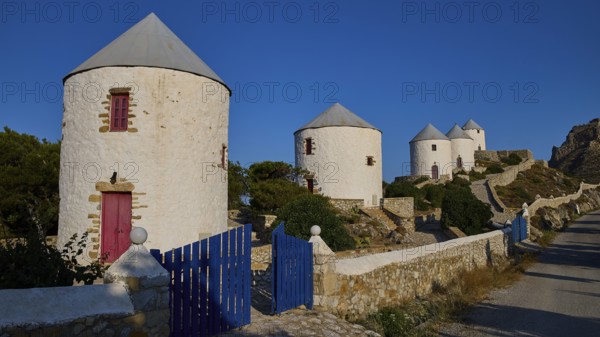 Four windmills behind a blue gate, along a road, Pandeli Castle, Castle, Leros Fortress, St John's Fortress, Apitiki Hill, Pandeli Bay, Windmills, Leros, Dodecanese, Greek Islands, Greece