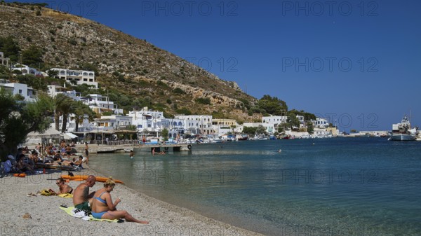 People relaxing on a sunny beach in a Greek coastal settlement, Pandeli Beach, Pandeli Castle, Castle, Leros Fortress, St John's Fortress, Apitiki Hill, Pandeli Bay, Windmills, Leros, Dodecanese, Greek Islands, Greece
