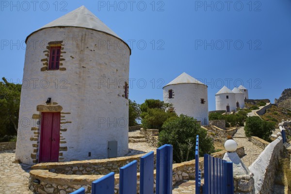 White windmills with red doors and fence under a blue sky on a sunny island, Pandeli Castle, Castle, Leros Fortress, St John's Fortress, Apitiki Hill, Pandeli Bay, Windmills, Leros, Dodecanese, Greek Islands, Greece