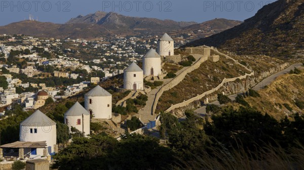 Row of windmills overlooking village, nestled in hilly landscape, Pandeli Castle, Castle, Leros Fortress, St John's Fortress, Apitiki Hill, Pandeli Bay, Windmills, Leros, Dodecanese, Greek Islands, Greece