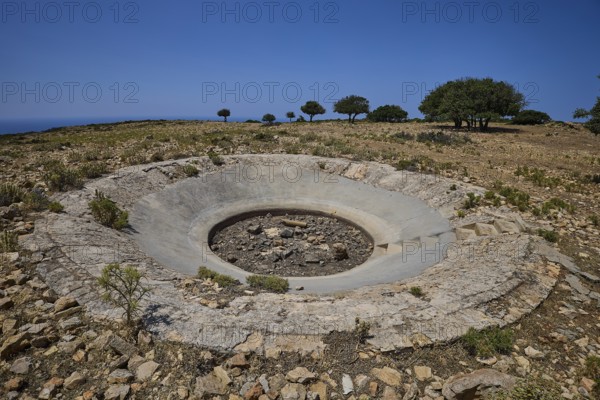 Large concrete crater in an open, rocky landscape under a clear sky, Lost Place, Air Defence Position, Aerophone, Parabolic Acoustic Mirror, Patella Mountain, WW2, west of Lakki, Leros, Dodecanese, Greek Islands, Greece