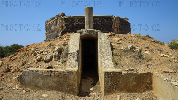 Entrance to a concrete structure on a rocky, dry hill, Lost Place, Air Defence Position, Aerophone, Parabolic Acoustic Mirror, Patella Mountain, WW2, west of Lakki, Leros, Dodecanese, Greek Islands, Greece