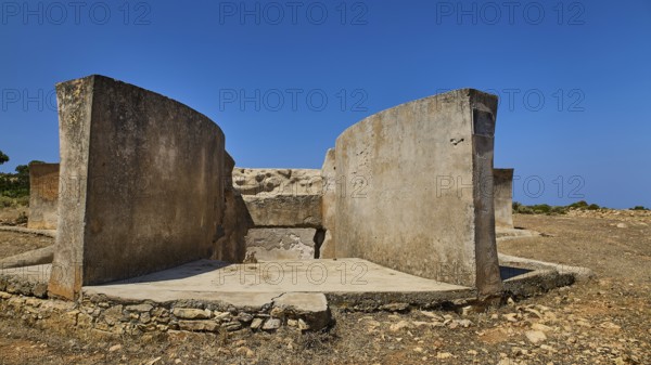 Massive concrete ruin in dry landscape with clear blue sky, Lost Place, Air Defence Position, Aerophone, Parabolic Acoustic Mirror, Patella Mountain, WW2, west of Lakki, Leros, Dodecanese, Greek Islands, Greece