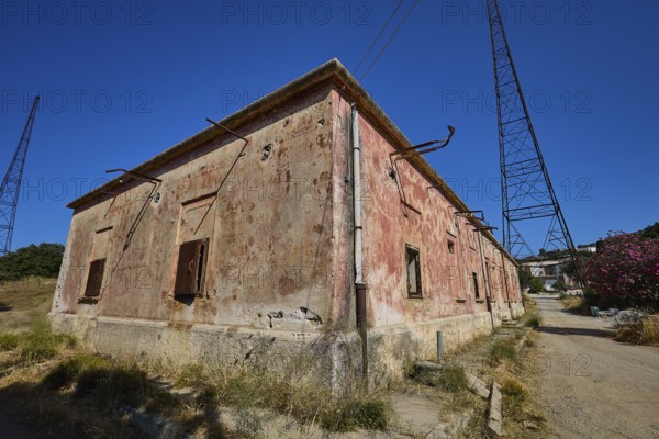 Lost Place, Old building with rusty pipes and electricity tower under clear sky, Radio Station, WW2, Agios Nikolaos Radio, Agia Marina, Leros, Dodecanese, Greek Islands, Greece