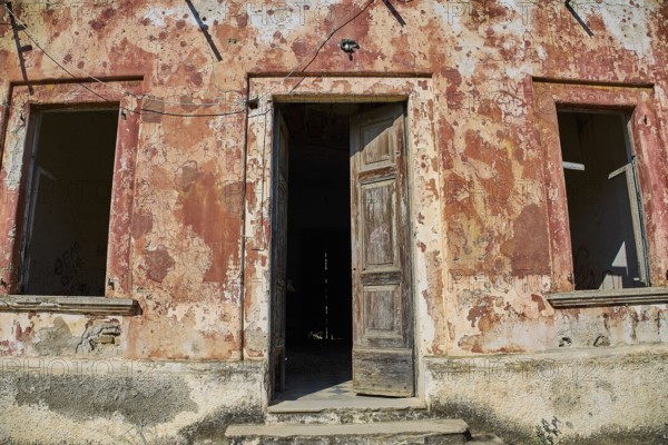Lost Place, Old façade with open door and peeling plaster, a picture of decay, Radio Station, WW2, Agios Nikolaos Radio, Agia Marina, Leros, Dodecanese, Greek Islands, Greece