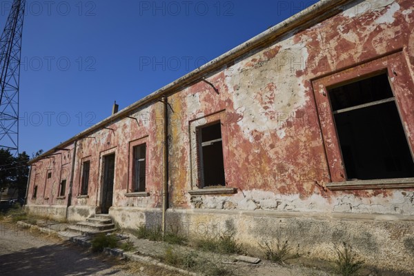 Lost Place, Long abandoned building with peeling red paint and open entrance, Radio Station, WW2, Agios Nikolaos Radio, Agia Marina, Leros, Dodecanese, Greek Islands, Greece