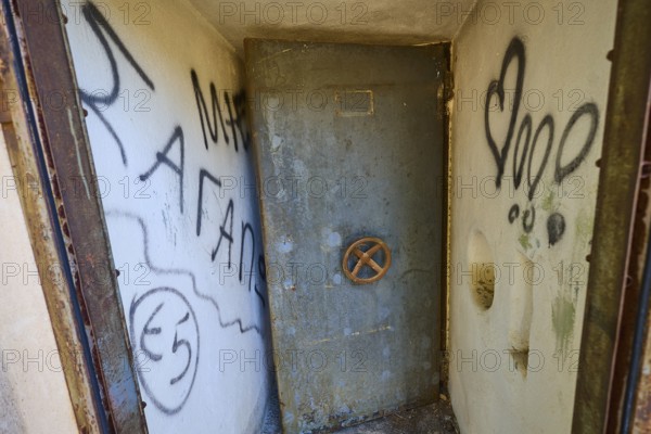 Lost Place, Small room with graffiti-covered metal door and worn appearance, Radio Station, WW2, Agios Nikolaos Radio, Agia Marina, Leros, Dodecanese, Greek Islands, Greece
