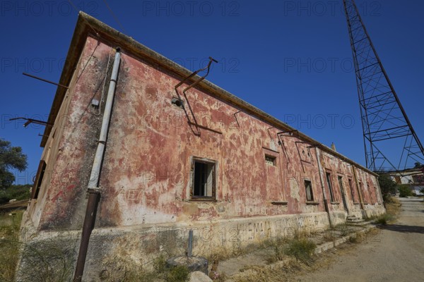 Lost Place, Red, peeling building with electric poles and cables under the open sky, Antenna mast, Radio Station, WW2, Agios Nikolaos Radio, Agia Marina, Leros, Dodecanese, Greek Islands, Greece