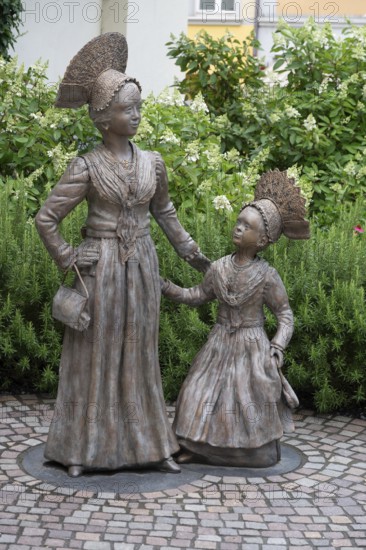 Two bronze sculptures, Überlingen women in festive traditional costume, created in 2023 by the sculptor Daniela Einsdorf, Überlingen, Baden-Württemberg, Germany