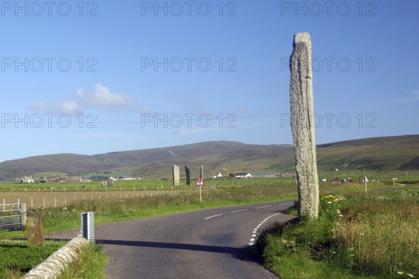 High stone next to a road with hills in the background, Ring of Brodgar, stone circle, Mainland, Orkney Islands, Scotland, Great Britain