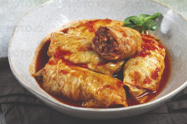 Stuffed cabbage rolls with minced meat, in tomato sauce, top view, without people, in the spotlight
