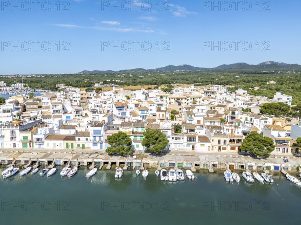 Portocolom fishing village on Majorca aerial view from above with boats holiday by the sea trip in Portocolom, Spain