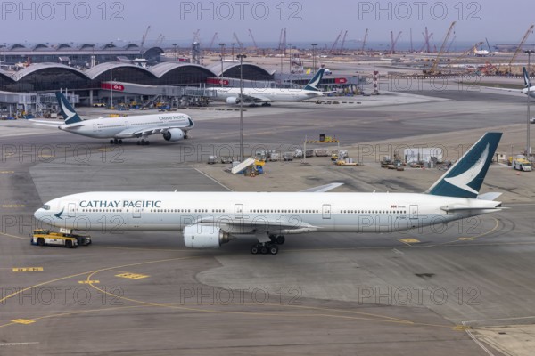 A Cathay Pacific Boeing 777-300 aircraft with the registration B-HNH at Chek Lap Kok Airport (HKG) in Hong Kong, China