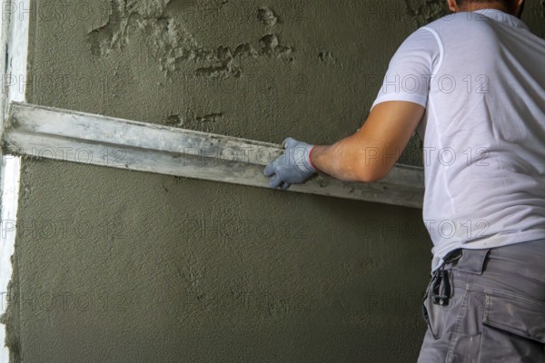 Plasterer smoothing interior walls