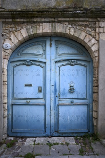 Old, weathered Tor tor, portal, light blue, old town, Bayeux, Normandy, Calvados, France