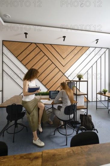 Two women discussing their a startup in the field of women's health in a contemporary office