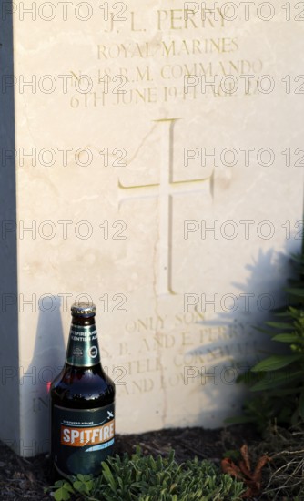 Bottle of Spitfire Kentish Ale, beer, at a gravestone, war graves, military graves, British and German military cemetery, Cimetière militaire britannique, D-Day, Operation Overlord, evening light, Bayeux, Normandy, Calvados, France